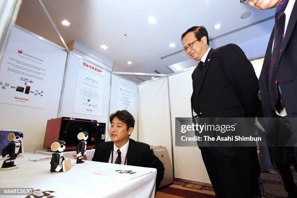 Cambodian Minister of Commerce Pan Sorasak watches 'Robohon' developped by Sharp during the meeting at the Japan - the Association of Southeast Asian...
