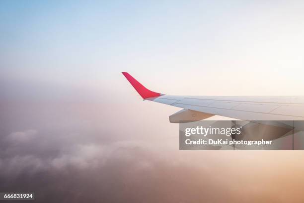 airplane wing in flight sunset - aircraft wing stock pictures, royalty-free photos & images