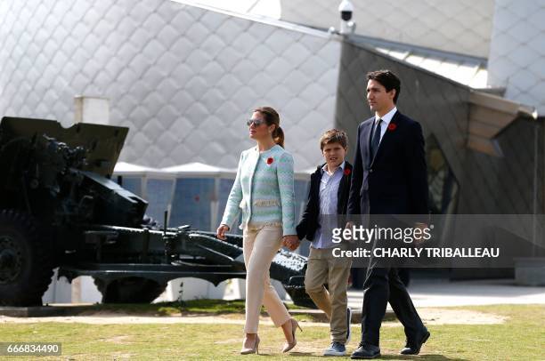 Canadian Prime Minister Justin Trudeau, his wife Sophie Gregoire and son Xavier walk outside the Juno Beach center, a museum in Courseulles-sur-Mer,...