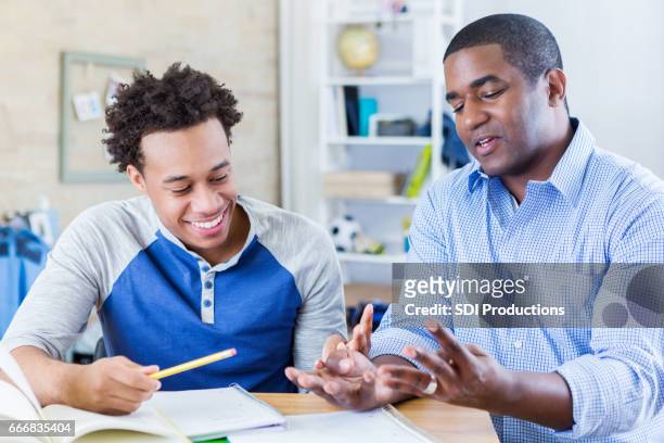dad helps teenage son with homework - role model stock pictures, royalty-free photos & images