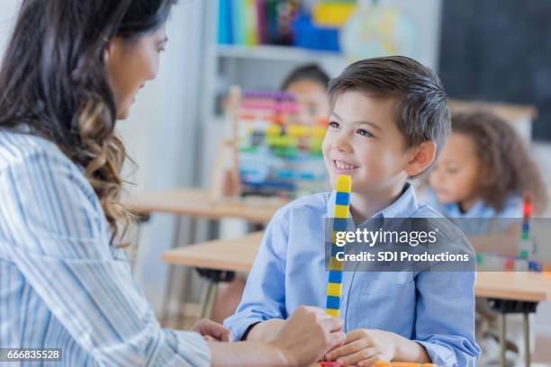 adorable mixed race schoolboy in math class - public school building stock pictures, royalty-free photos & images