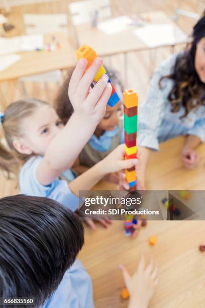 preschool student uses counting blocks at school - public school building stock pictures, royalty-free photos & images