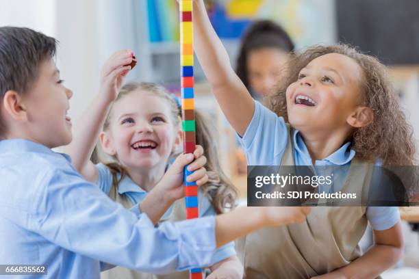 diverse preschool friends play with counting cubes - private school uniform stock pictures, royalty-free photos & images