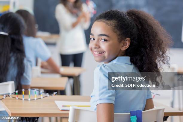 confident middle schoolgirl in science class - private school uniform stock pictures, royalty-free photos & images