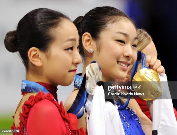 South Korea's Kim Yu Na shows her gold medal, and Japan's Mao Asada her silver medal, at the Vancouver Olympics in February 2010. Asada announced her...