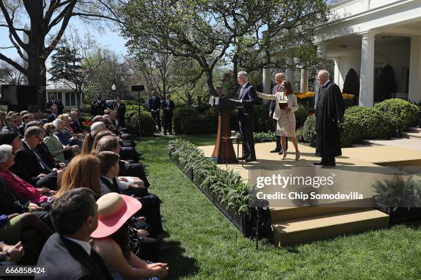 Supreme Court Associate Justice Neil Gorsuch's wife Marie Louise Gorsuch touches his back as he delivers remarks following the administration of the...