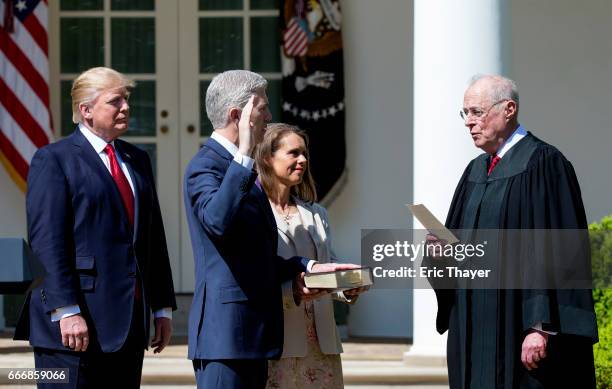 Supreme Court Associate Justice Anthony Kennedy administers the judicial oath to Judge Neil Gorsuch as President Donald Trump looks on during a...