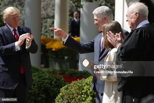 Supreme Court Associate Justice Neil Gorsuch acknowledges supporters after taking the judicial oath during a Rose Garden ceremony with his wife Marie...