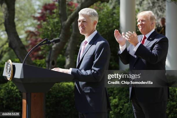 President Donald Trump applauds as Supreme Court Associate Justice Neil Gorsuch delivers remarks after taking the judicial oath during a ceremony in...