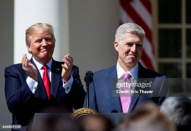 Supreme Court Justice Judge Neil Gorsuch speaks as President Donald Trump looks on during a ceremony in the Rose Garden at the White House April 10,...