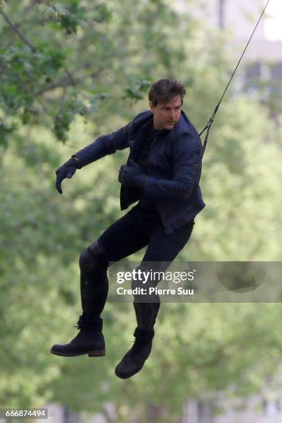 Actor Tom Cruise performs a stunt on set for 'Mission:Impossible 6 Gemini' filming on April 10, 2017 in Paris, France.