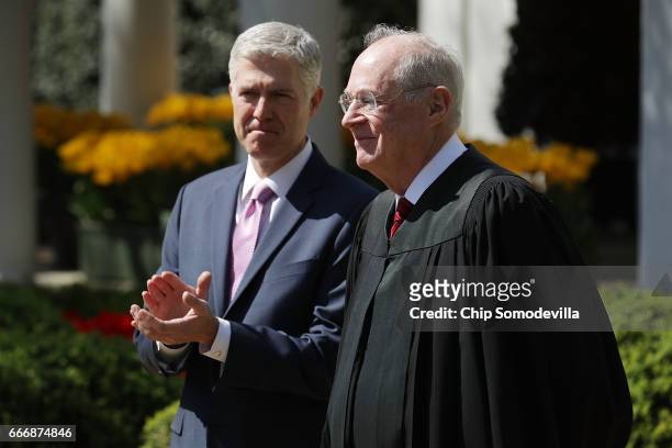 Supreme Court Associate Justice Anthony Kennedy prepares to administer the judicial oath to Judge Neil Gorsuch during a ceremony in the Rose Garden...