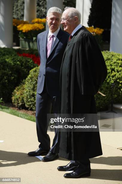 Supreme Court Associate Justice Anthony Kennedy prepares to administer the judicial oath to Judge Neil Gorsuch during a ceremony in the Rose Garden...