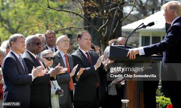 Supreme Court Chief Justice John Roberts and associate justices Clarence Thomas, Ruth Bader Ginsburg, Stephen Breyer and Samuel Alito applaud for...