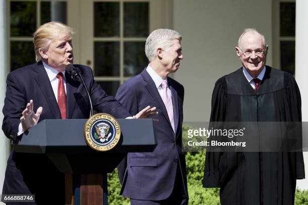 President Donald Trump, from right, speaks while Judge Neil Gorsuch and Associate Justice Anthony Kennedy smile during the swearing in ceremony of...