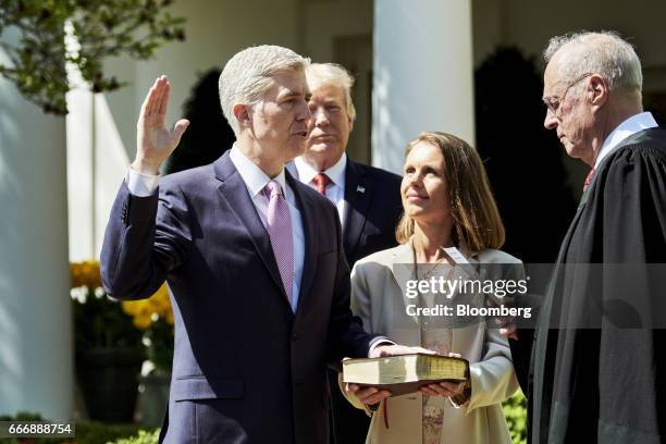 Associate Justice Anthony Kennedy, right, administers the judicial oath to Judge Neil Gorsuch, left, as his wife Louise Gorsuch and U.S. President...