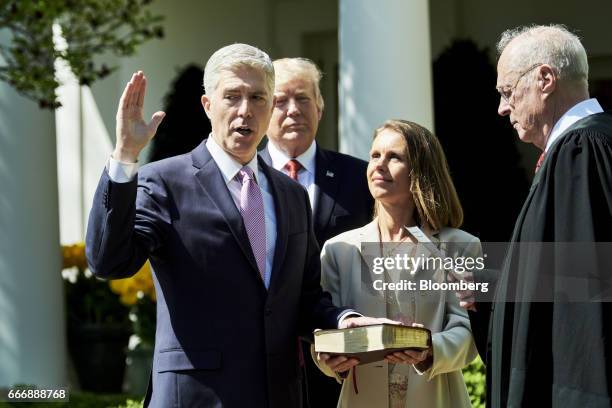 Associate Justice Anthony Kennedy, right, administers the judicial oath to Judge Neil Gorsuch, left, as his wife Louise Gorsuch and U.S. President...