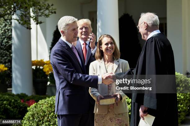 Supreme Court Justice Neil Gorsuch, left, shakes hands with Associate Justice Anthony Kennedy, right, after taking the oath of office as U.S....