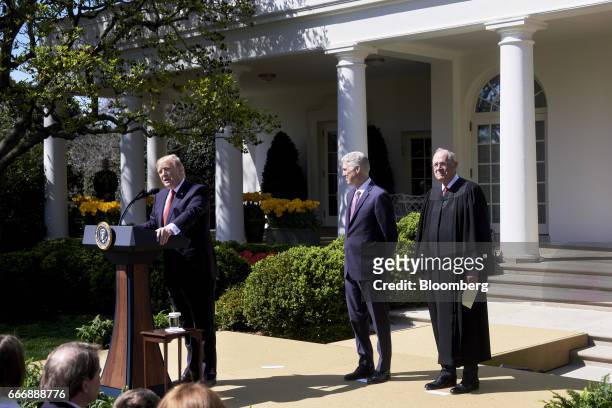 President Donald Trump, right, speaks while Judge Neil Gorsuch, center, and Associate Justice Anthony Kennedy listen during the swearing in ceremony...