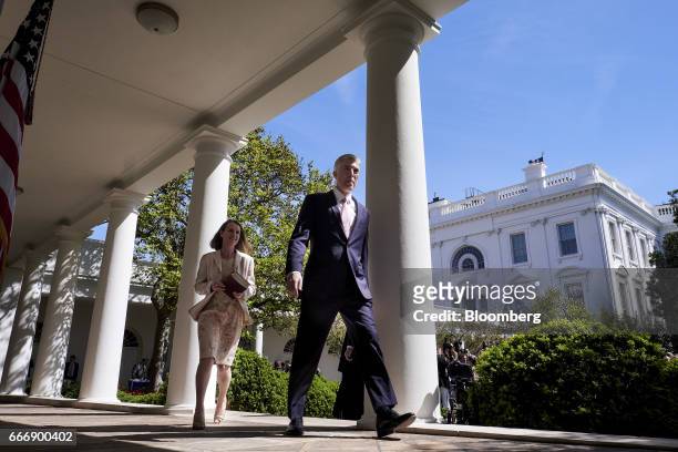 Supreme Court Justice Neil Gorsuch, right, leaves with his wife Louise Gorsuch after taking the oath of office during a ceremony in the Rose Garden...
