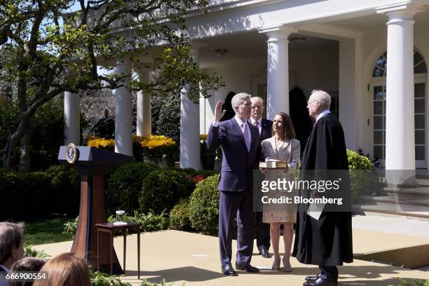Associate Justice Anthony Kennedy, right, administers the judicial oath to Judge Neil Gorsuch, left, as his wife Louise Gorsuch and U.S. President...