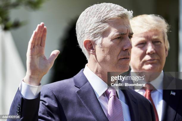 Judge Neil Gorsuch, left, recites the oath of office as U.S. Donald President Trump listen during the swearing in ceremony of Gorsuch as U.S. Supreme...