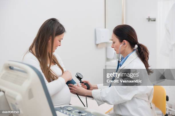 pregnancy ultrasound in doctors office - hypertensive stock pictures, royalty-free photos & images