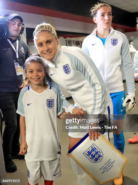 Captain Steph Houghton of England poses with a mascot prior to the Women's International Friendly match between England and Austria at Stadium mk on...