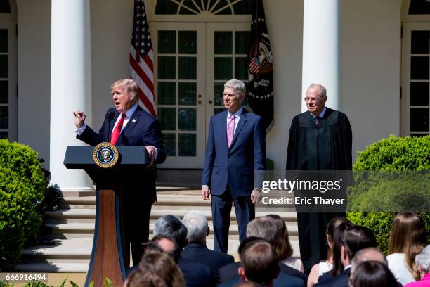 President Donald Trump speaks as U.S. Supreme Court Associates Justice Neil Gorsuch and Anthony Kennedy watch during a ceremony in the Rose Garden at...