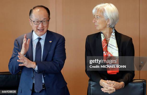 Jim Yong Kim , President of the World Bank and Christine Lagarde, Managing Director of the International Monetary Fund talk with a member of the...