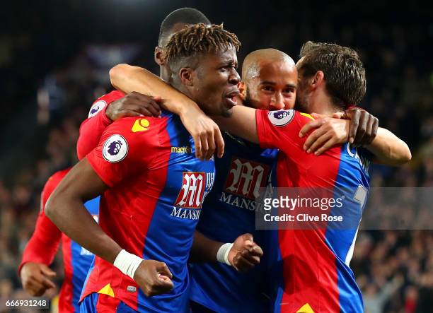 Andros Townsend of Crystal Palace celebrates with Wilfried Zaha and Yohan Cabaye as he scores their first goal during the Premier League match...