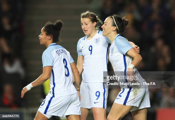 Lucy Bronze of England celebrates as she scores their second goal with Demi Stokes and Ellen White during the Women's International Friendly match...