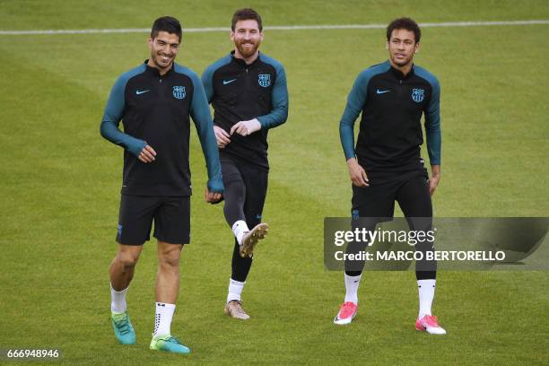 Barcelona's forward Lionel Messi from Argentina , Barcelona's forward Luis Suarez from Uruguay and Barcelona's forward Neymar from Brazil take part...