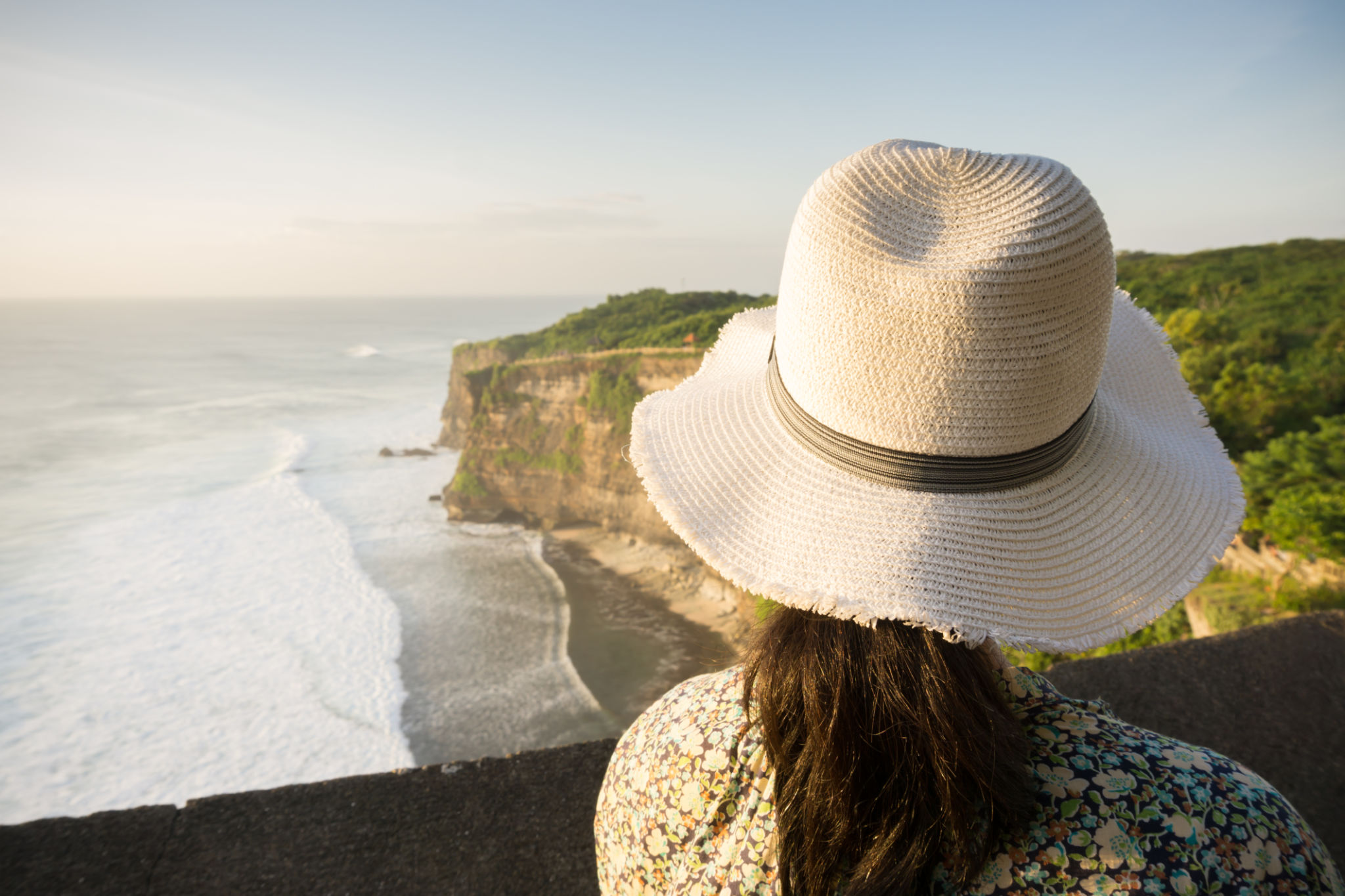Beautiful woman watching Uluwatu seascape in vacation Beautiful woman watching Uluwatu seascape in vacation