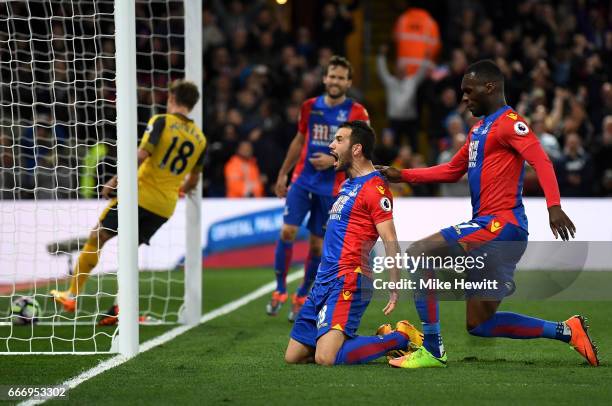 Luka Milivojevic of Crystal Palace celebrates as he scores their third goal from a penalty with Christian Benteke of Crystal Palace during the...