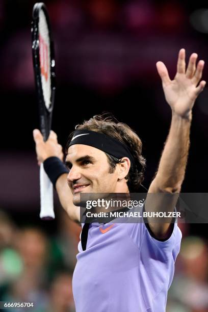 Swiss tennis superstar Roger Federer reacts after winning a charity match "The Match for Africa 3" against world number one Britain's Andy Murray on...