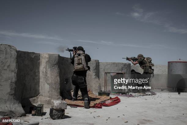 Iraqi Counter Terrorism Service soldiers fire at Islamic State fighters in Al Yarmuk, west Mosul, April 10, 2017. The ICTS retook the district. Iraqi...