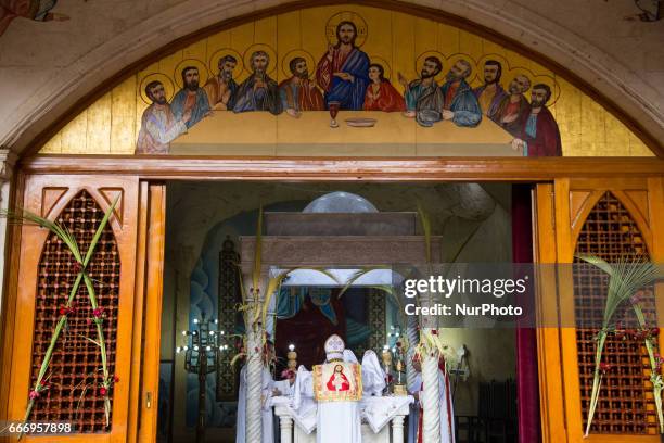Christians pray during Palm Sunday mass inside the Cave Cathedral or St. Sama'ans Church on the Mokattam hills overlooking Cairo, Egypt on 9 April...