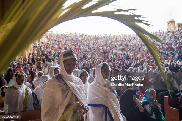 Christians pray during Palm Sunday mass inside the Cave Cathedral or St. Sama'ans Church on the Mokattam hills overlooking Cairo, Egypt on 9 April...