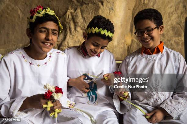 Christians pray during Palm Sunday mass inside the Cave Cathedral or St. Sama'ans Church on the Mokattam hills overlooking Cairo, Egypt on 9 April...