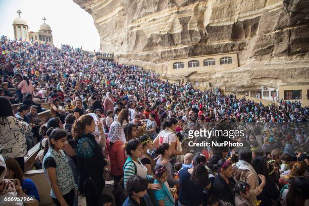 Christians pray during Palm Sunday mass inside the Cave Cathedral or St. Sama'ans Church on the Mokattam hills overlooking Cairo, Egypt on 9 April...