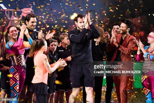 Swiss tennis superstar Roger Federer and world number one Britain's Andy Murray celebrate at the end of a charity match "The Match for Africa 3" on...