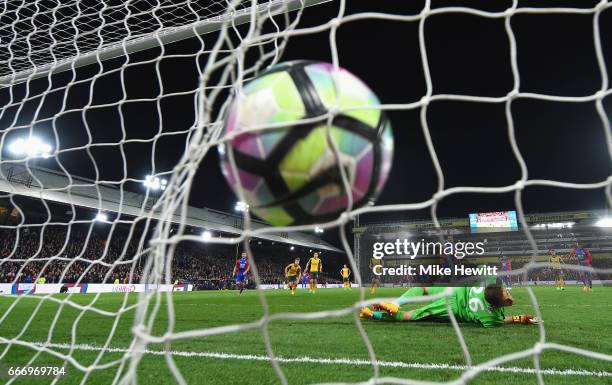 Luka Milivojevic of Crystal Palace scores their third goal from a penalty past goalkeeper Emiliano Martinez of Arsenal during the Premier League...