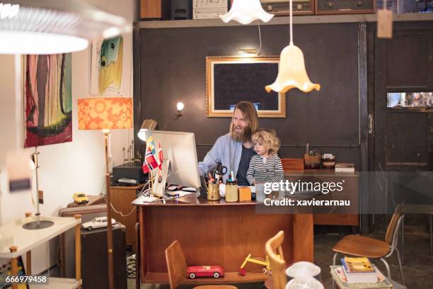 Owner Using Computer With Son In Furniture Shop High-Res Stock Photo ...