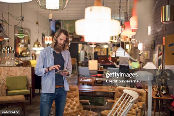 owner using digital tablet in furniture store - furniture store stock pictures, royalty-free photos & images