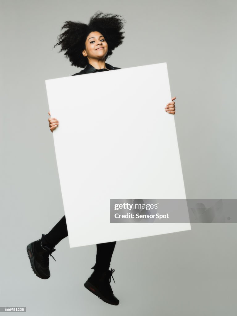 African woman jholding a blank billboard