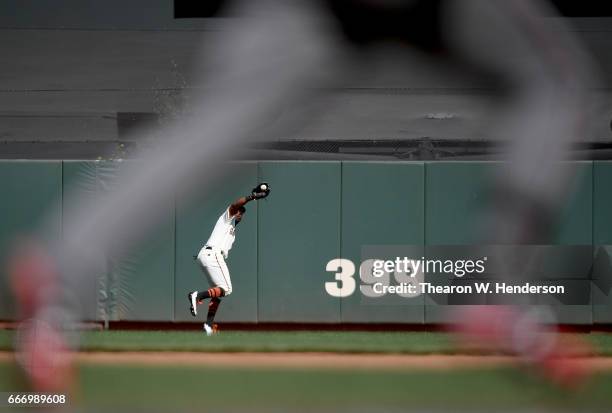 Denard Span of the San Francisco Giants runs down a fly ball off the bat of Jake Lamb of the Arizona Diamondbacks in the top of the seventh inning at...