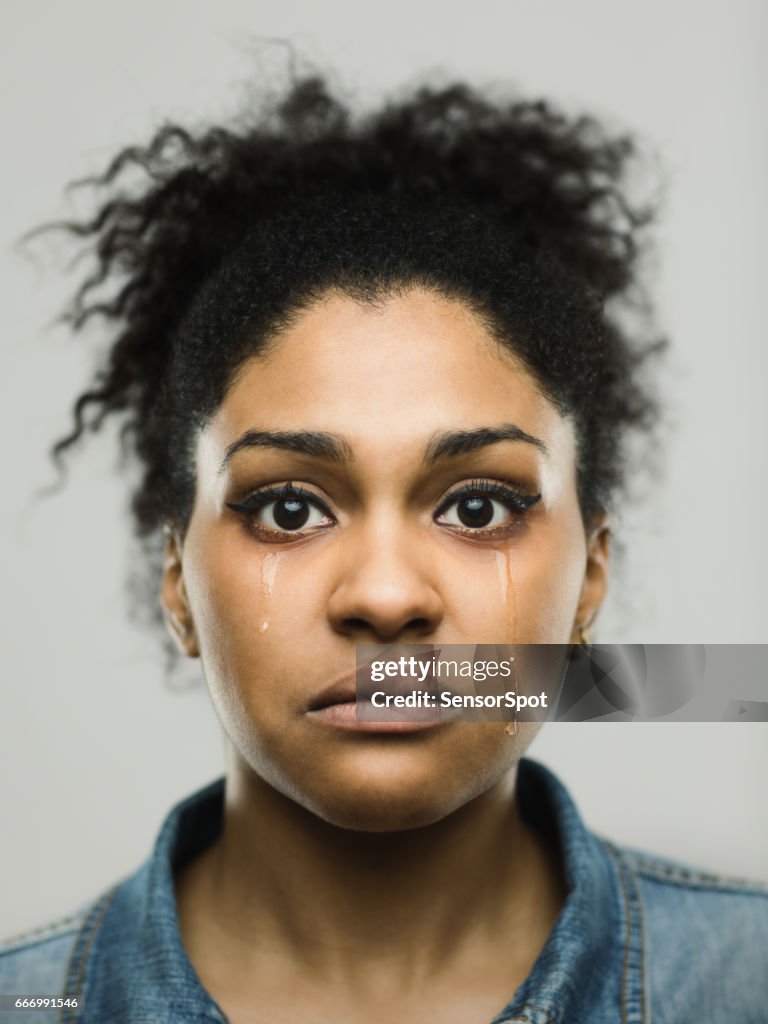 Close-up portrait of crying young afro american woman