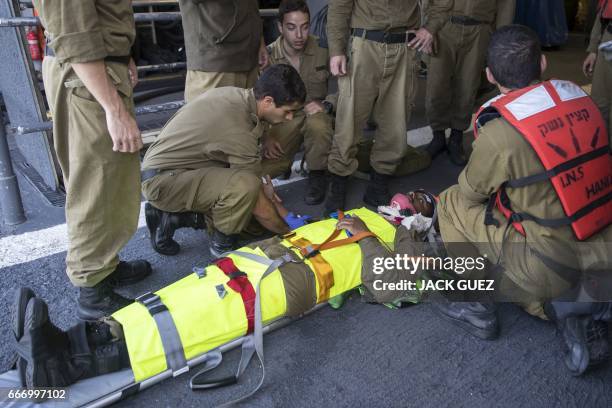 Israeli soldiers onboard the Israeli vessel Saar 5 Class Corvette "INS Hanit" attend a medical training session during the "Novel Dina 17" exercise...