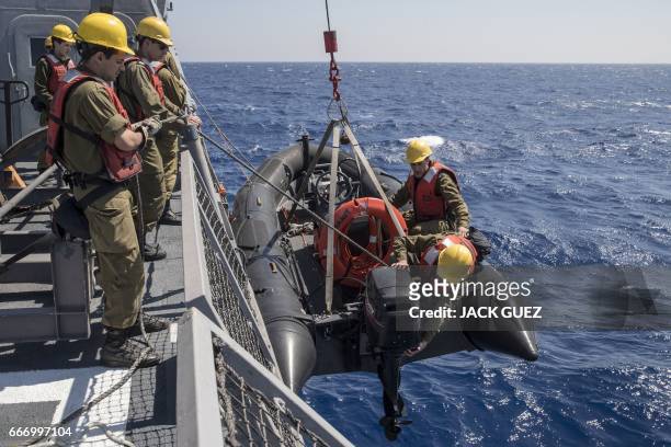 Israeli soldiers onboard the Israeli vessel Saar 5 Class Corvette "INS Hanit" prepare an inflatable boat during the "Novel Dina 17" exercise in the...